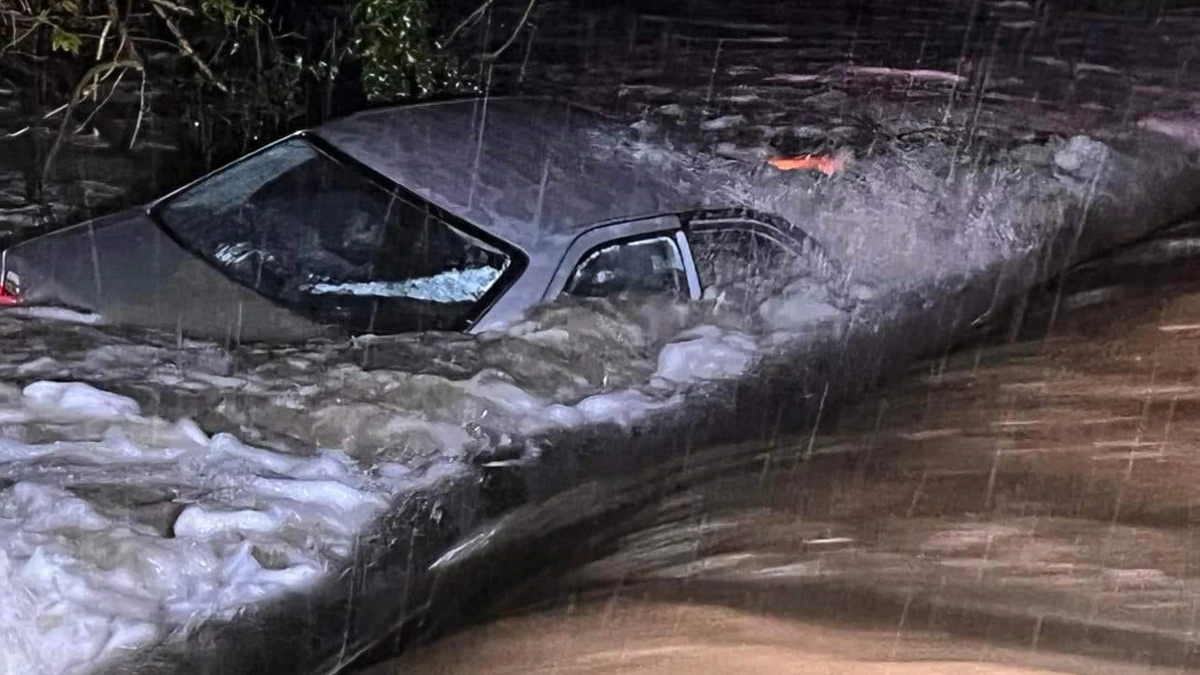 Northland firefighters save man trapped on car roof in raging torrent