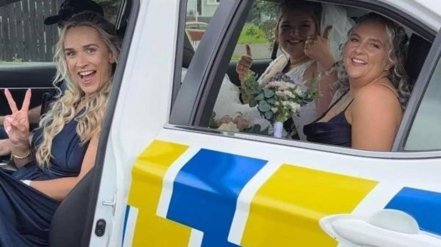Police officer offers stranded bride ride to wedding after highway breakdown